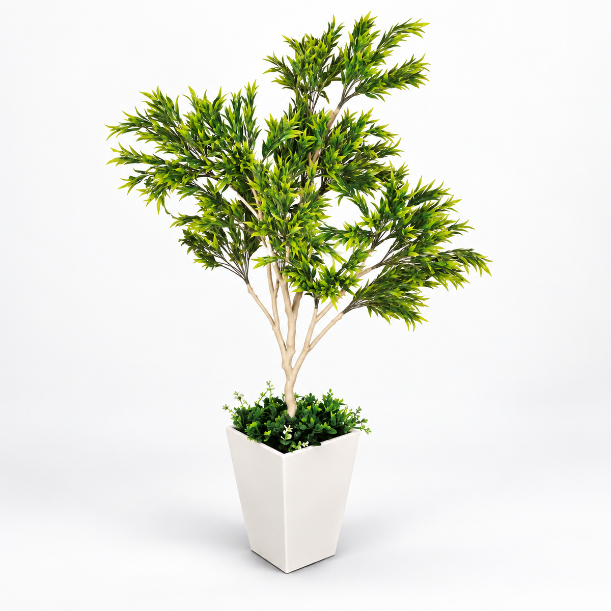 Artificial green foliage tree in white planter - side