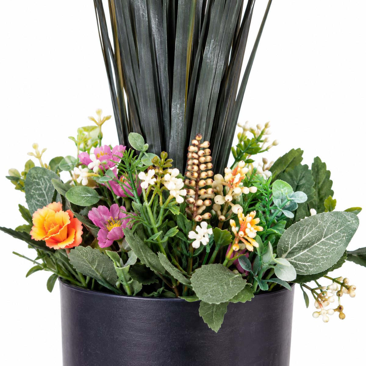 Artificial tall grass plant with wildflower base - closeup